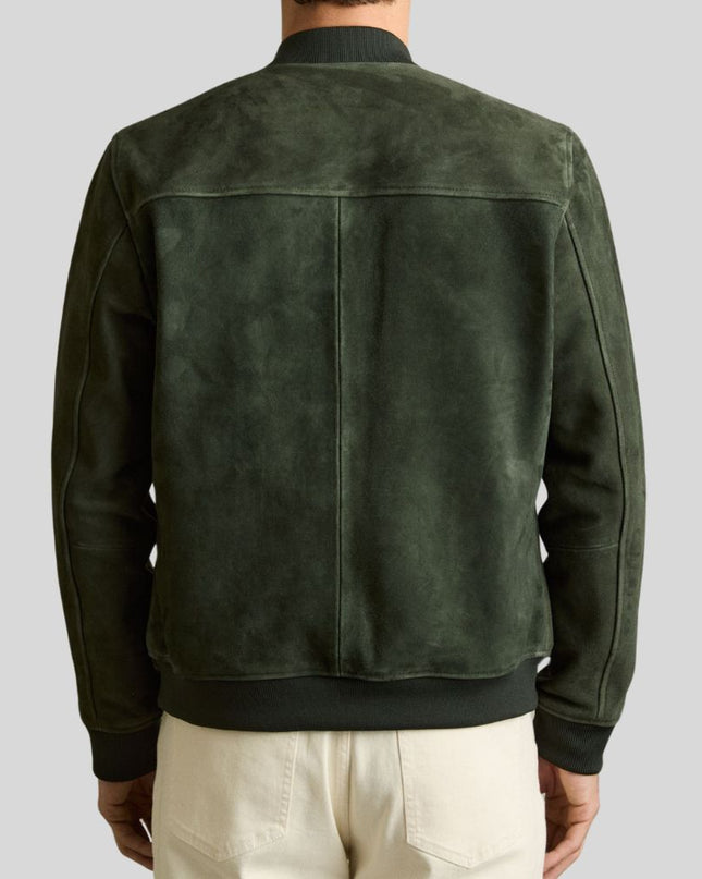 Green suede jacket worn by a person on a gray background