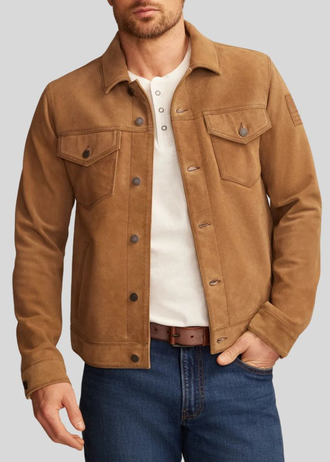 Man wearing a brown jacket, white shirt, and blue jeans on a gray background