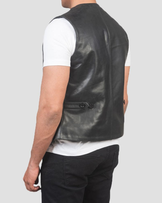 Person wearing a black leather vest on a gray background