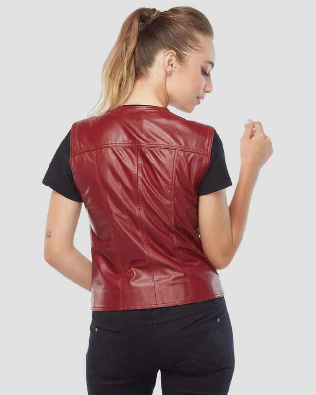 Woman wearing a red leather vest on a light gray background