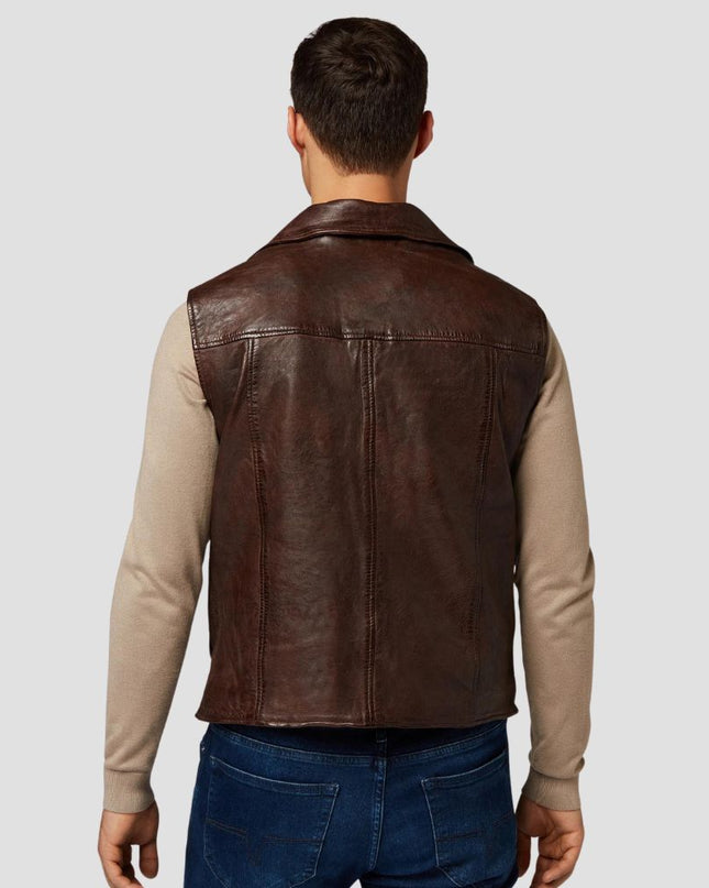 Man wearing a brown leather vest over a beige shirt on a light gray background