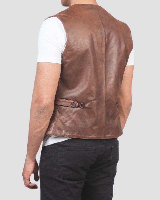 Brown leather vest worn by a person on a plain background