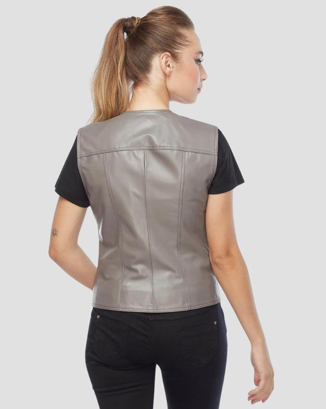 Woman wearing a gray leather vest on a white background