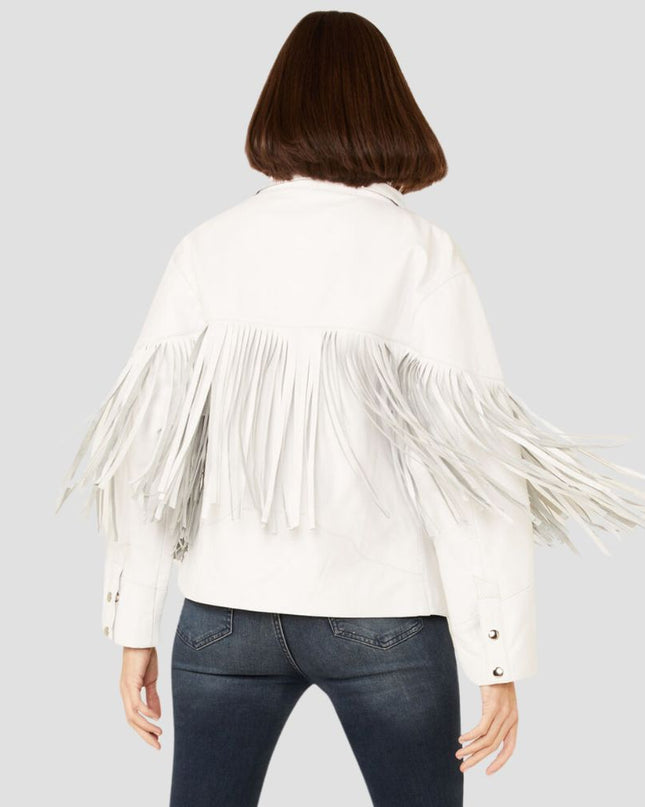 Person wearing a white fringed jacket on a plain background