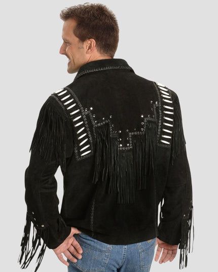 Man wearing a black fringed jacket with silver studs on a gray background