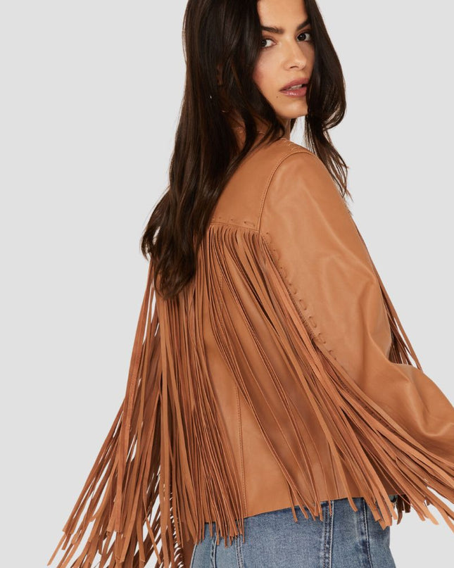 Woman wearing a brown fringe jacket on a white background