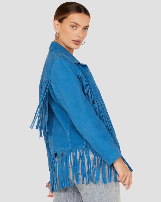 Woman wearing a blue fringed jacket on a plain background